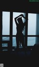 silhouette of woman standing in front of window