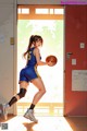 A woman in a blue and yellow uniform holding a basketball.