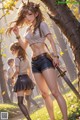 A girl with a sword standing next to another girl in a forest.